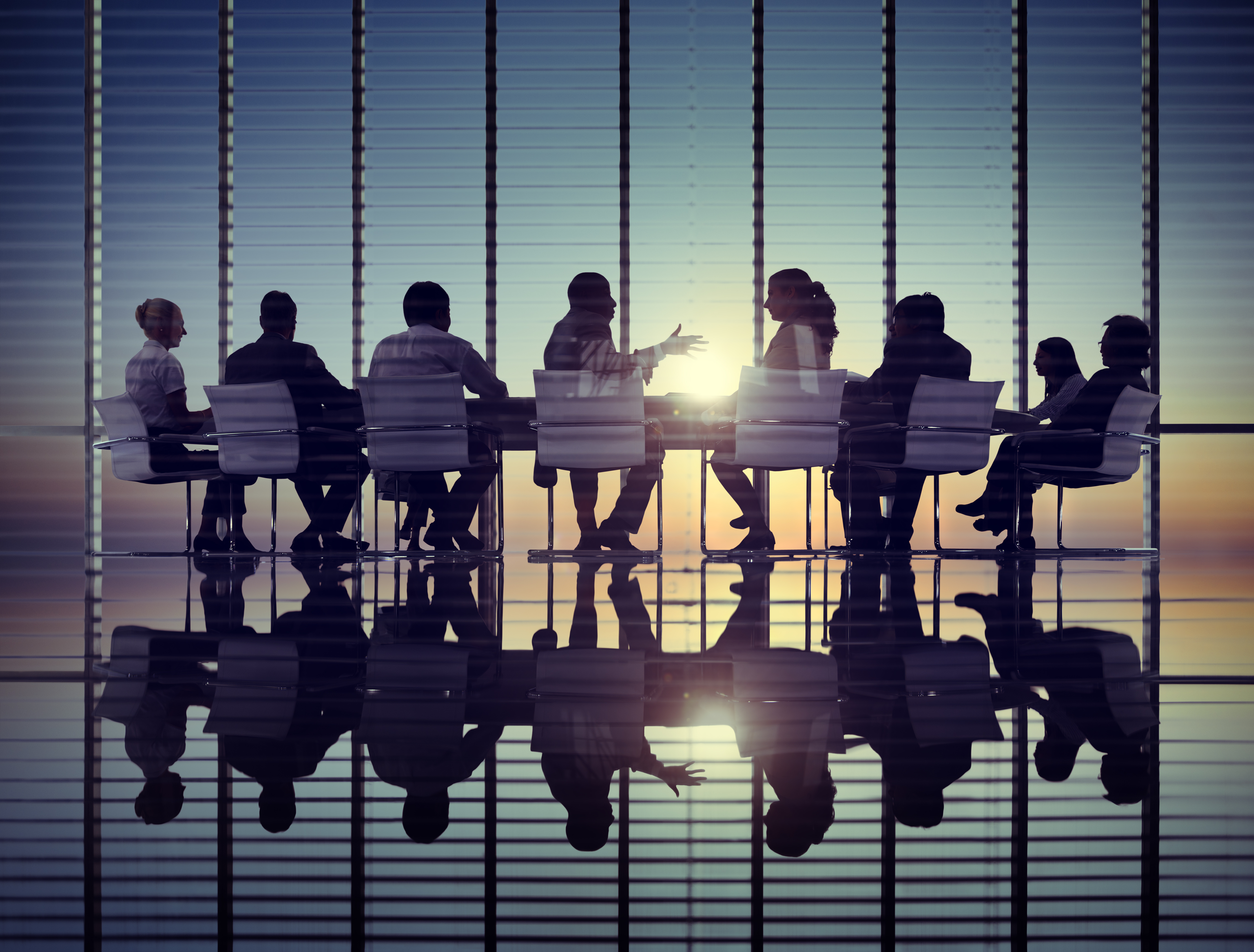 meeting in modern conference room with a sunset view